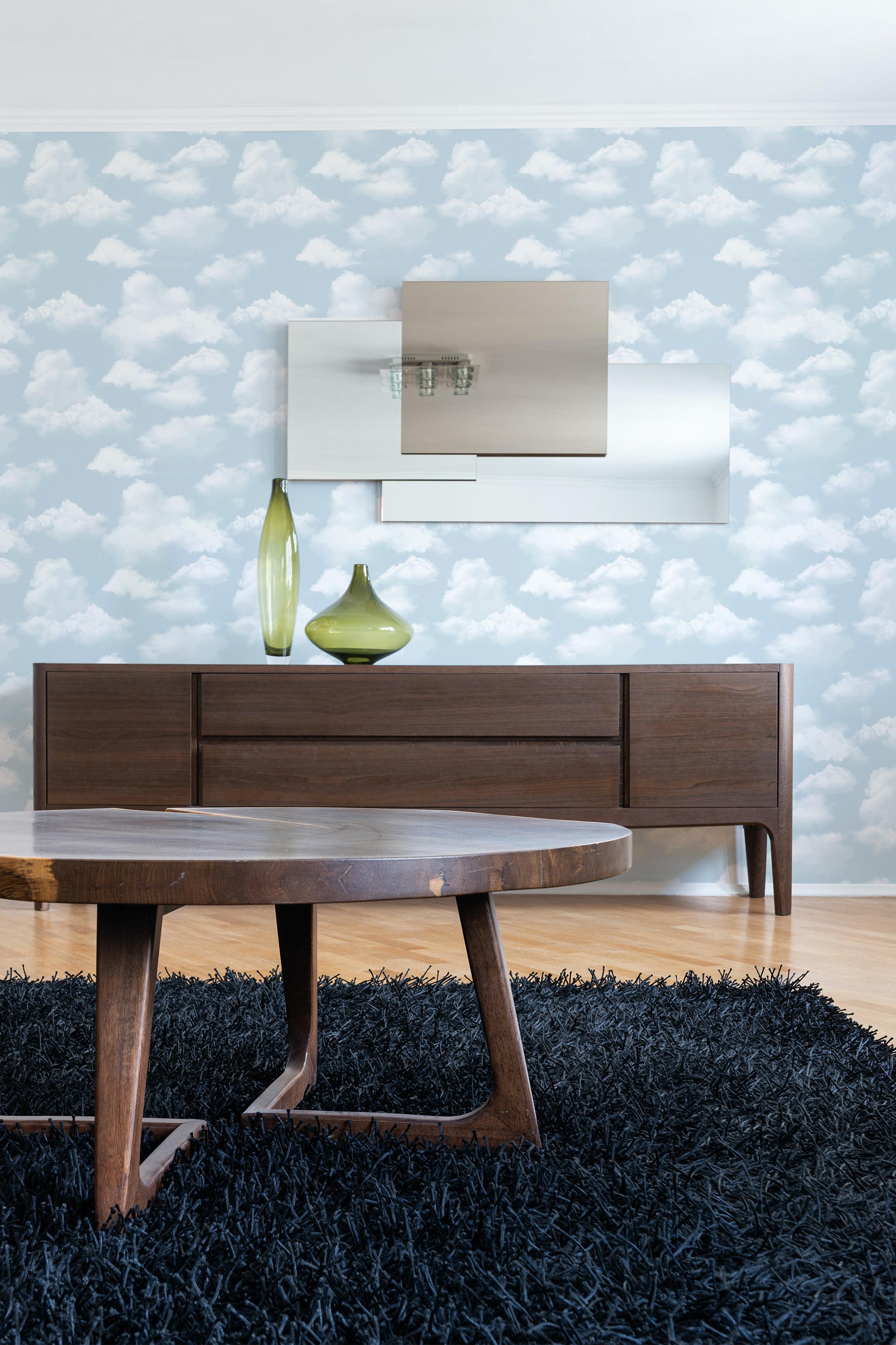 A soothing room with light blue wallpaper patterned with soft white clouds, creating a serene, sky-like atmosphere. Traditional wallpaper.