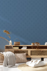 Wall with a blue turtle pattern in subtle, muted tones against a solid blue background, traditional wallpaper.