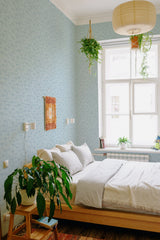 Light blue wallpaper with delicate palm tree patterns, adding a tropical feel to the room. Traditional wallpaper.