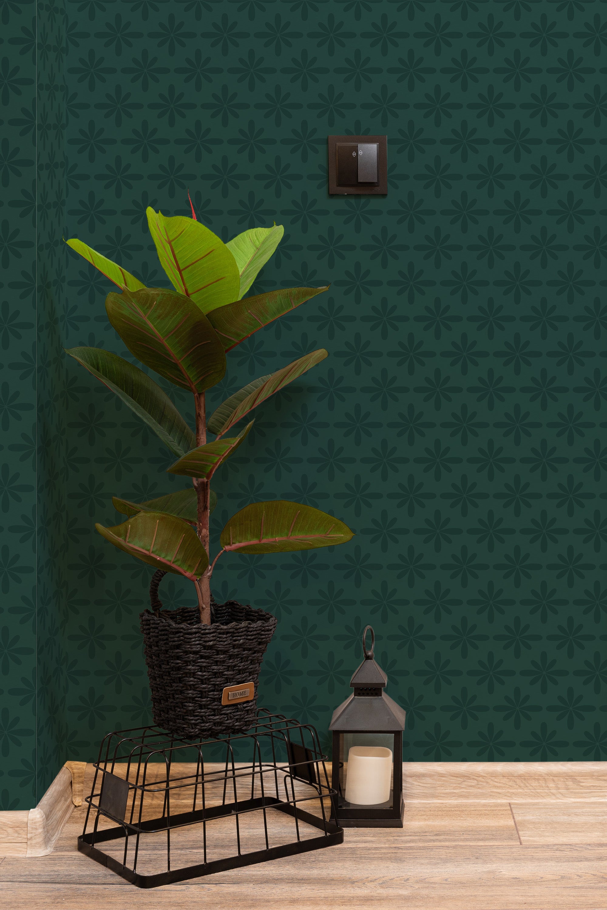 Self-adhesive wallpaper with a forest green background and subtle floral patterns in repeating geometric shapes, adding a calming and natural aesthetic to the room.