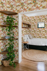 Colorful floral and abstract patterns in shades of green, orange, and brown arranged on a cream background, reflecting a vintage, retro aesthetic,raditional wallpaper.