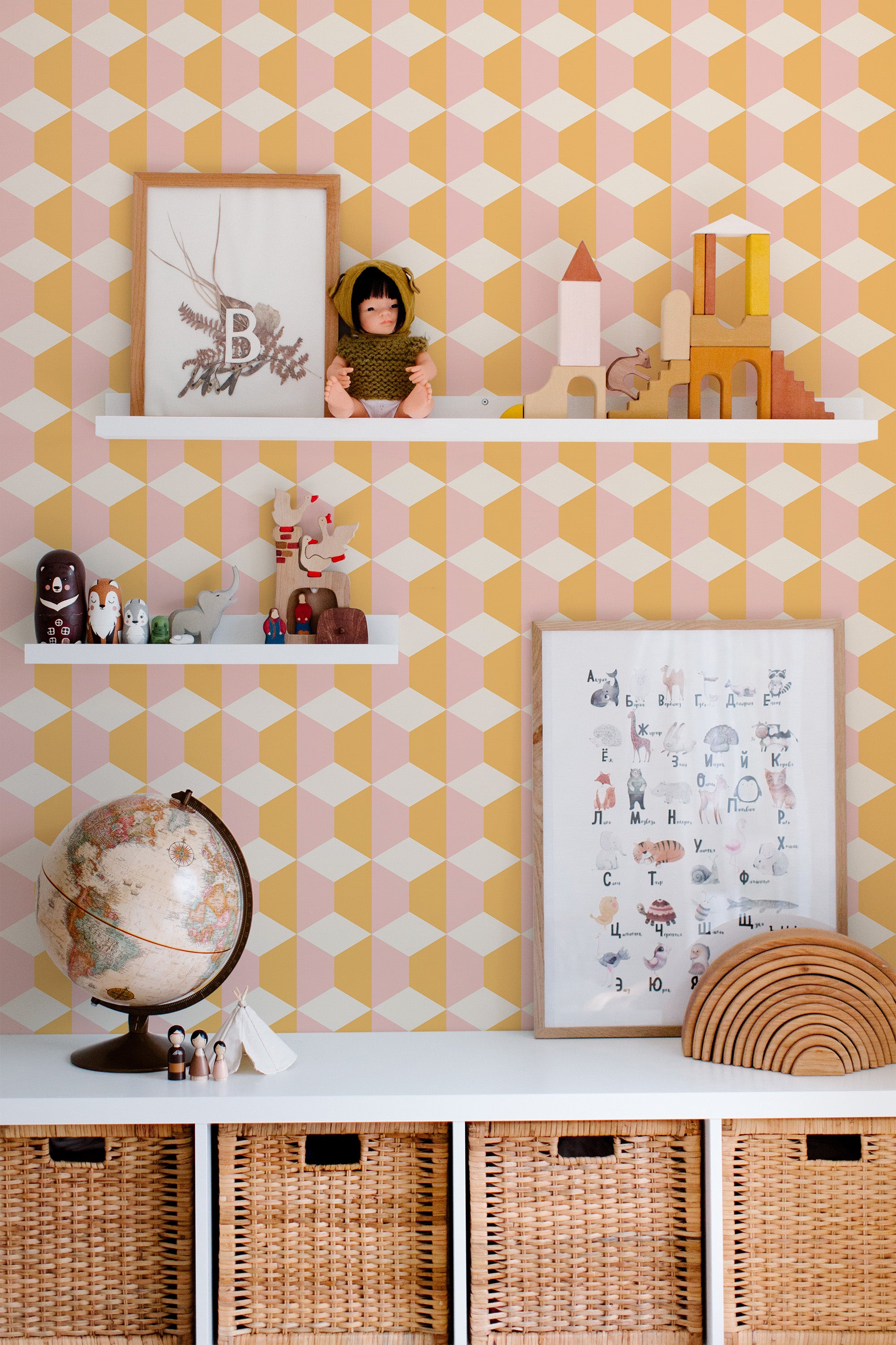 Self-adhesive pink and yellow geometric wallpaper with interlocking hexagon shapes creating a three-dimensional effect, adding a vibrant and playful element to the room.