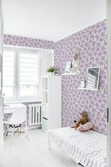 A cozy room with walls adorned with purple floral patterned wallpaper with leaves and vines intertwining across the surface, creating a soft and elegant atmosphere. Traditional wallpaper.
