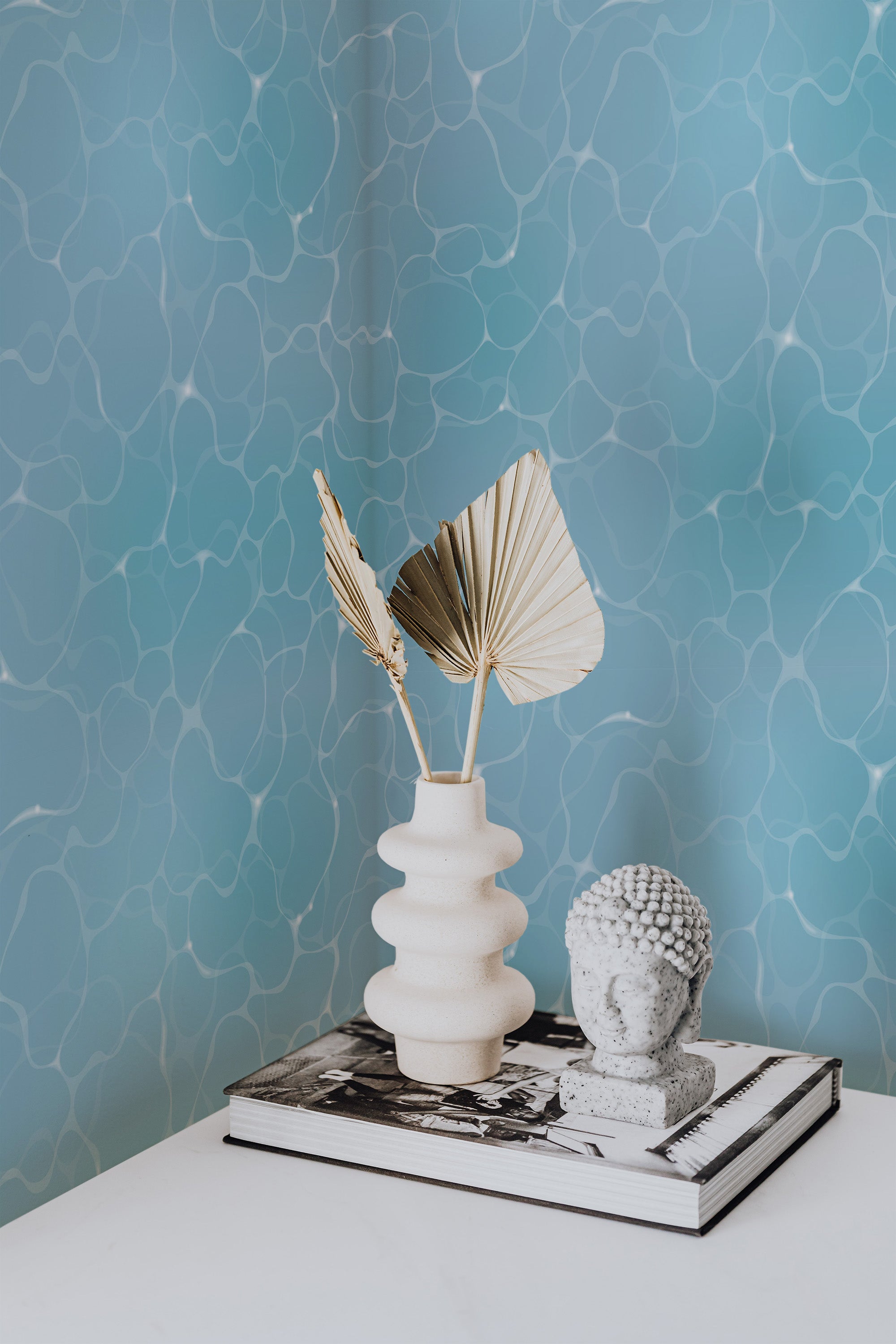 Self-adhesive wallpaper with a Swimming pool design in varying shades of blue, creating a rippling water effect on the wall.