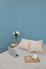 Self-adhesive wallpaper with a soothing wave pattern in varying shades of blue, creating a calming, ocean-like atmosphere in the room.