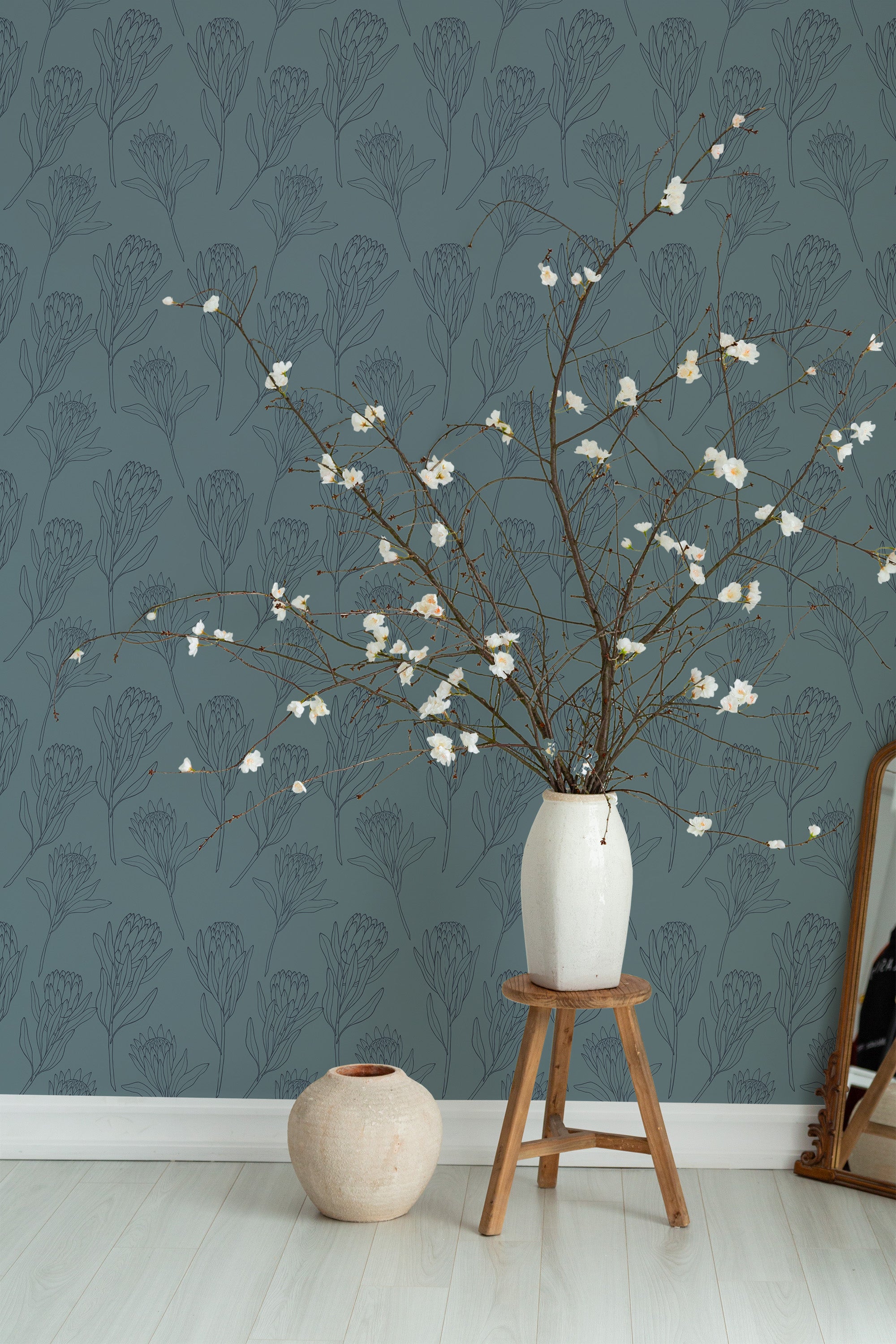 Self-adhesive wallpaper in a muted teal color with delicate line art of Protea flowers in dark gray, creating a subtle and elegant botanical pattern.