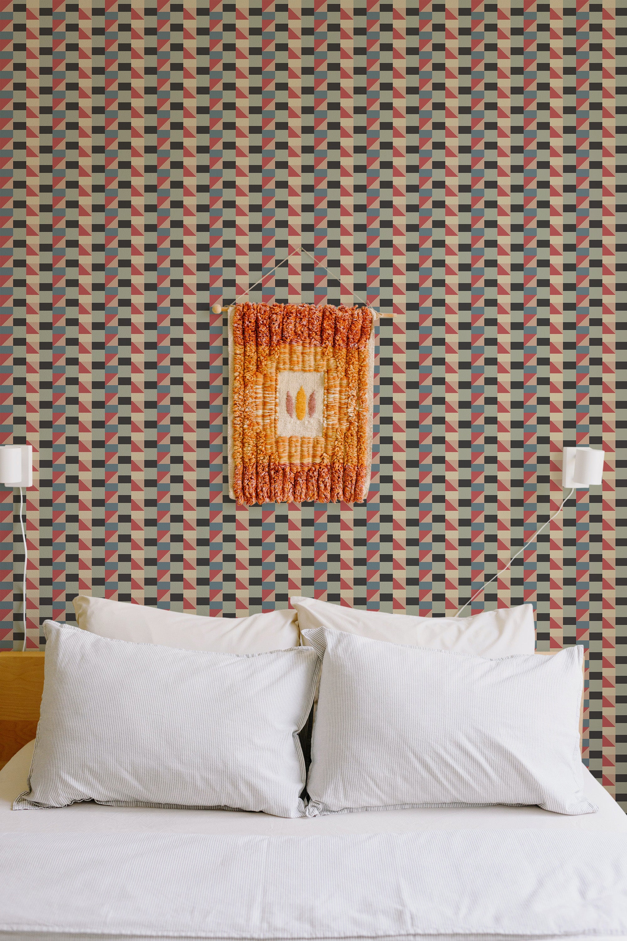 Self-adhesive wallpaper with a vintage textile imitation pattern featuring geometric shapes in shades of red, green, and cream, adding a retro vibe to the room.