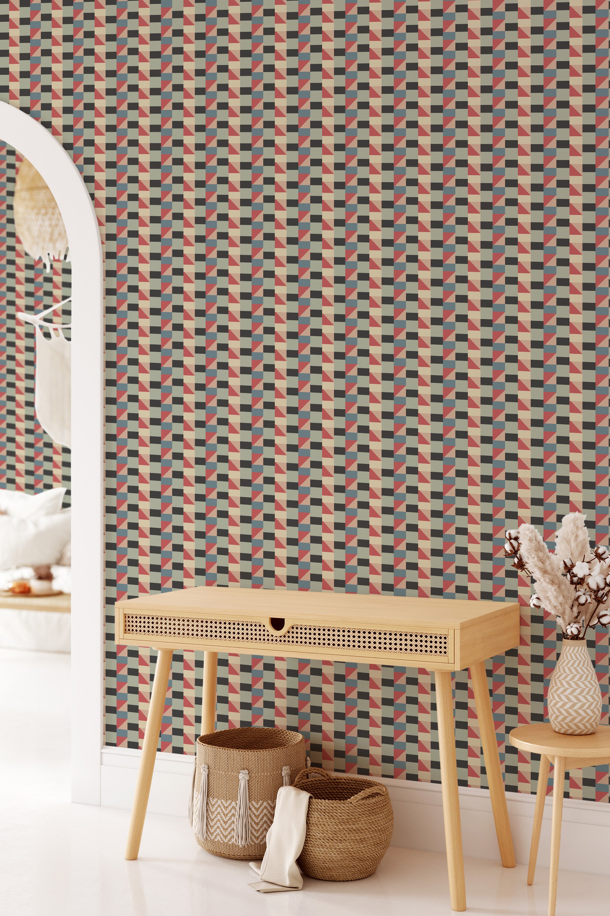 Geometric patterned wallpaper with a mix of mustard yellow, deep green, red, and beige tones in a repeating triangular shape design resembling vintage textile art, traditional wallpaper.