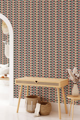 Geometric patterned wallpaper with a mix of mustard yellow, deep green, red, and beige tones in a repeating triangular shape design resembling vintage textile art, traditional wallpaper.