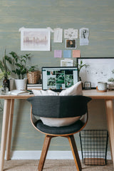 Self-adhesive wallpaper with a grass green texture and subtle horizontal lines, creating a natural and serene look in the room.
