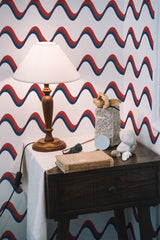 Self-adhesive wallpaper with a USA wave design, showing red, white, and blue wavy lines repeating horizontally across the wall for a patriotic effect.