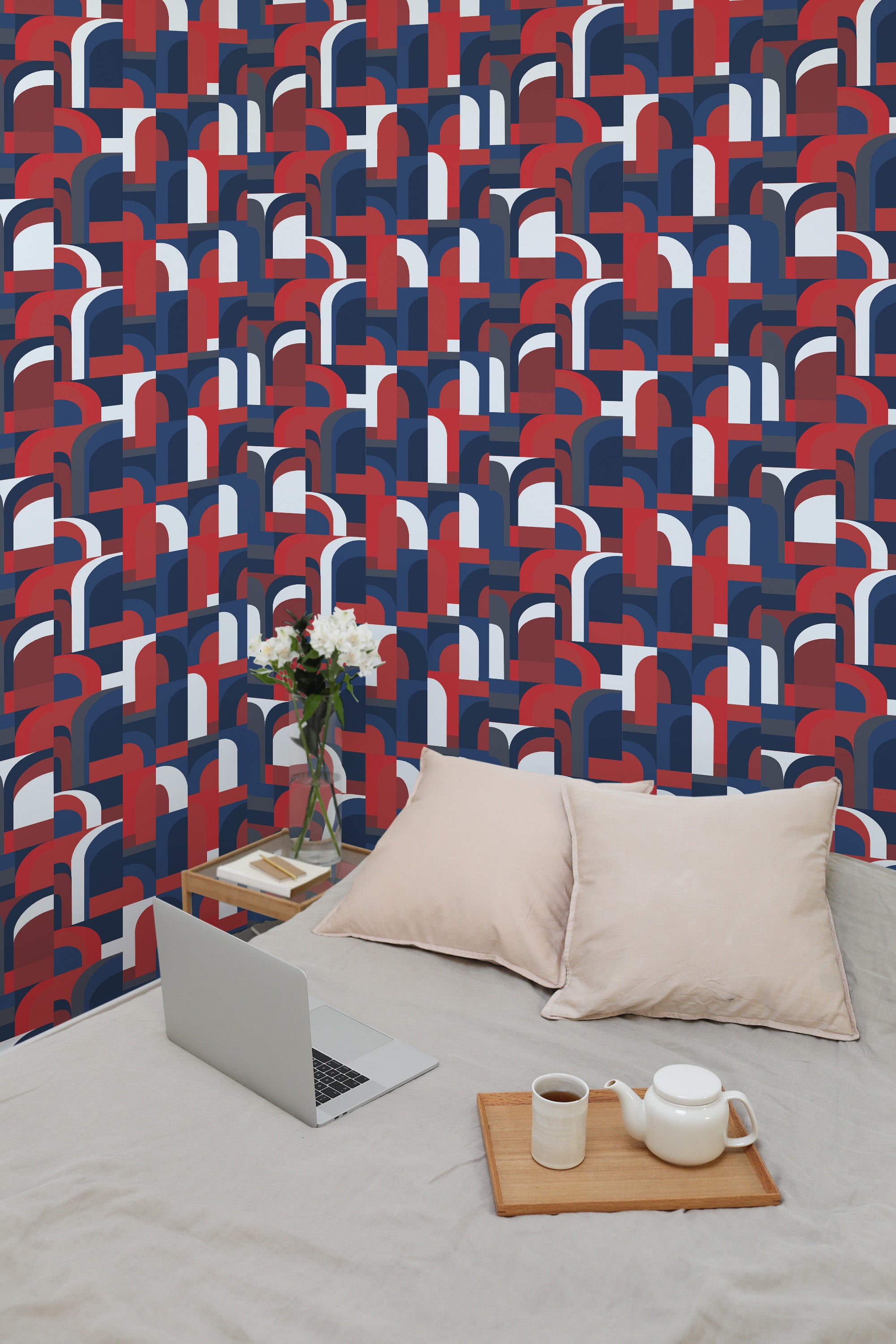 Self-adhesive 1970s-inspired wallpaper with a geometric design in bold shades of red, blue, and white, forming retro-style arches and curves.