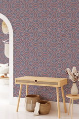 Paisley-patterned wallpaper in shades of red, white, and blue, creating an intricate and rhythmic design with floral motifs and teardrop shapes. Traditional wallpaper.