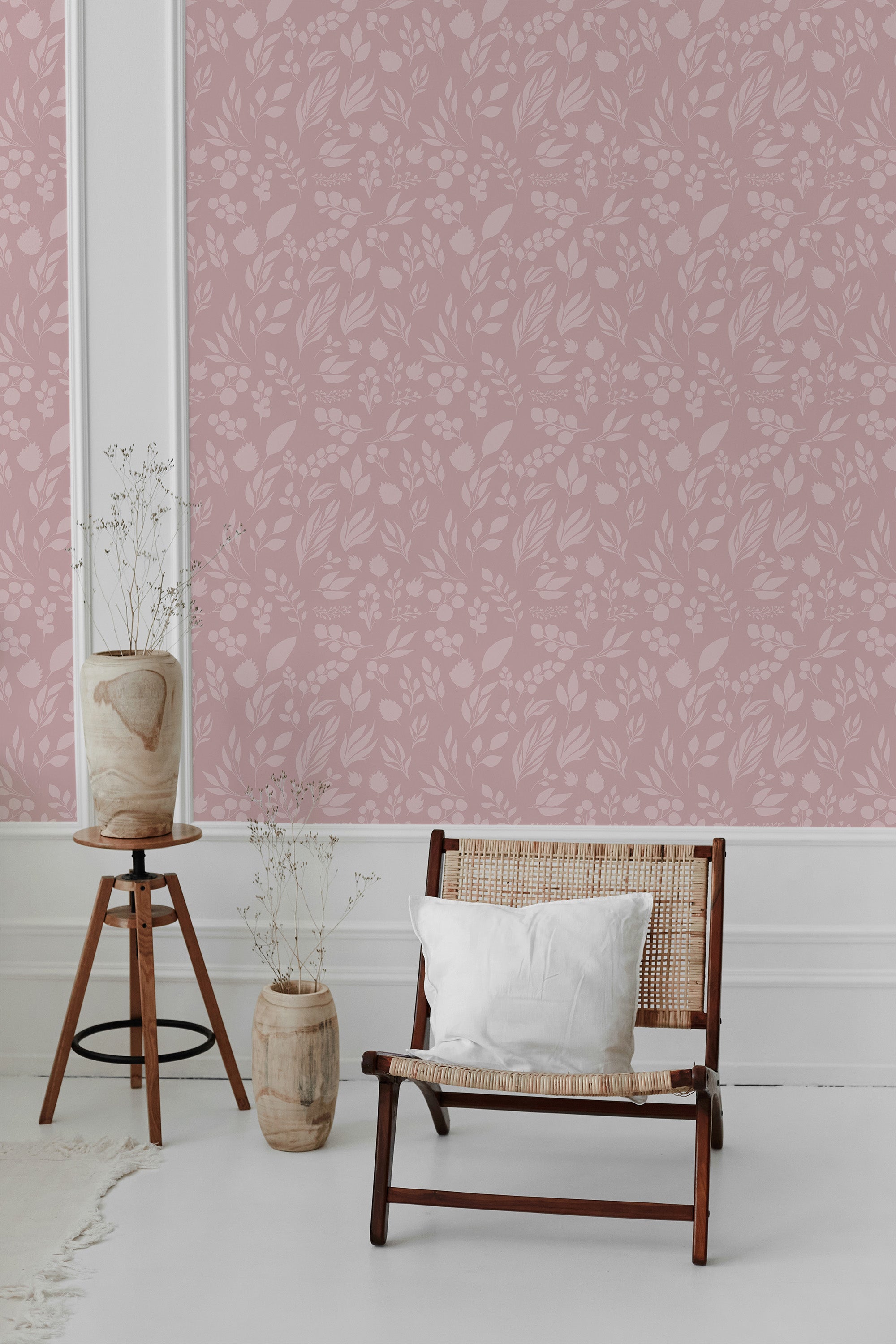 Pink wallpaper with a delicate pattern of leaves, flowers, and stems in a soft, muted tone adorns the wall, adding a subtle and elegant touch to the room. The design has a timeless aesthetic, creating an inviting and classic atmosphere. Traditional wallpaper.