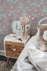 Self-adhesive wallpaper with a red branch design set against a soft light blue background, adding a natural and elegant touch to the room.
