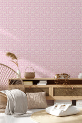 A room with light pink wallpaper patterned with delicate white vines and small blossoms, giving the space a soft and elegant feel. Traditional wallpaper.