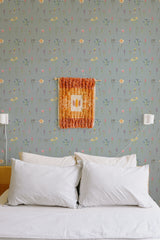 Self-adhesive wallpaper with a design of colorful wildflowers on a soft gray background, complementing the cozy, light-filled bedroom atmosphere.