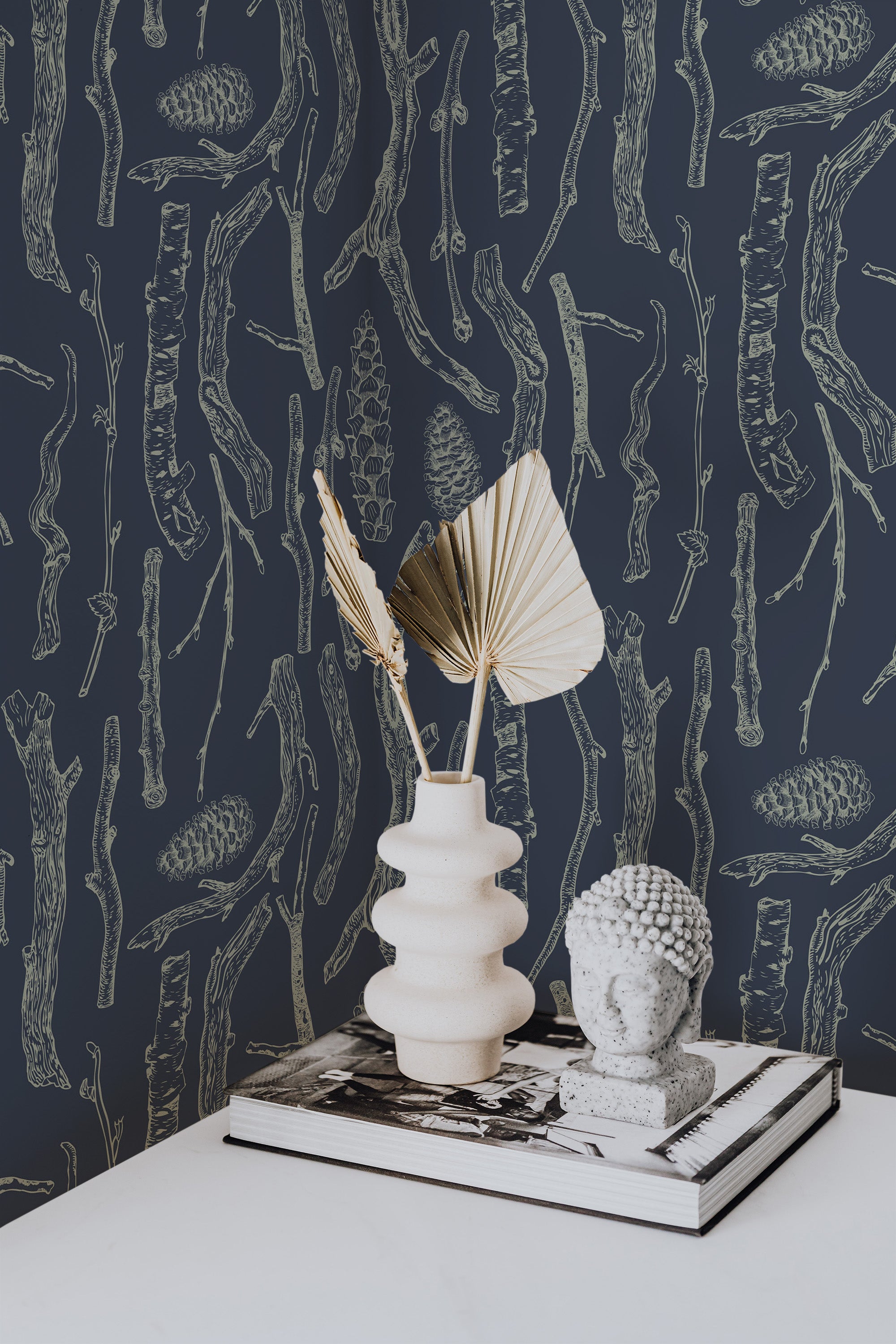 Self-adhesive wallpaper with a 'Branches' design, featuring detailed outlines of twigs, branches, and pinecones in light tones set against a dark background.