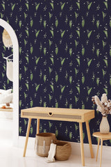 A room with navy blue wallpaper adorned with green leaves and white snowdrops, creating a natural, elegant pattern. Traditional wallpaper.