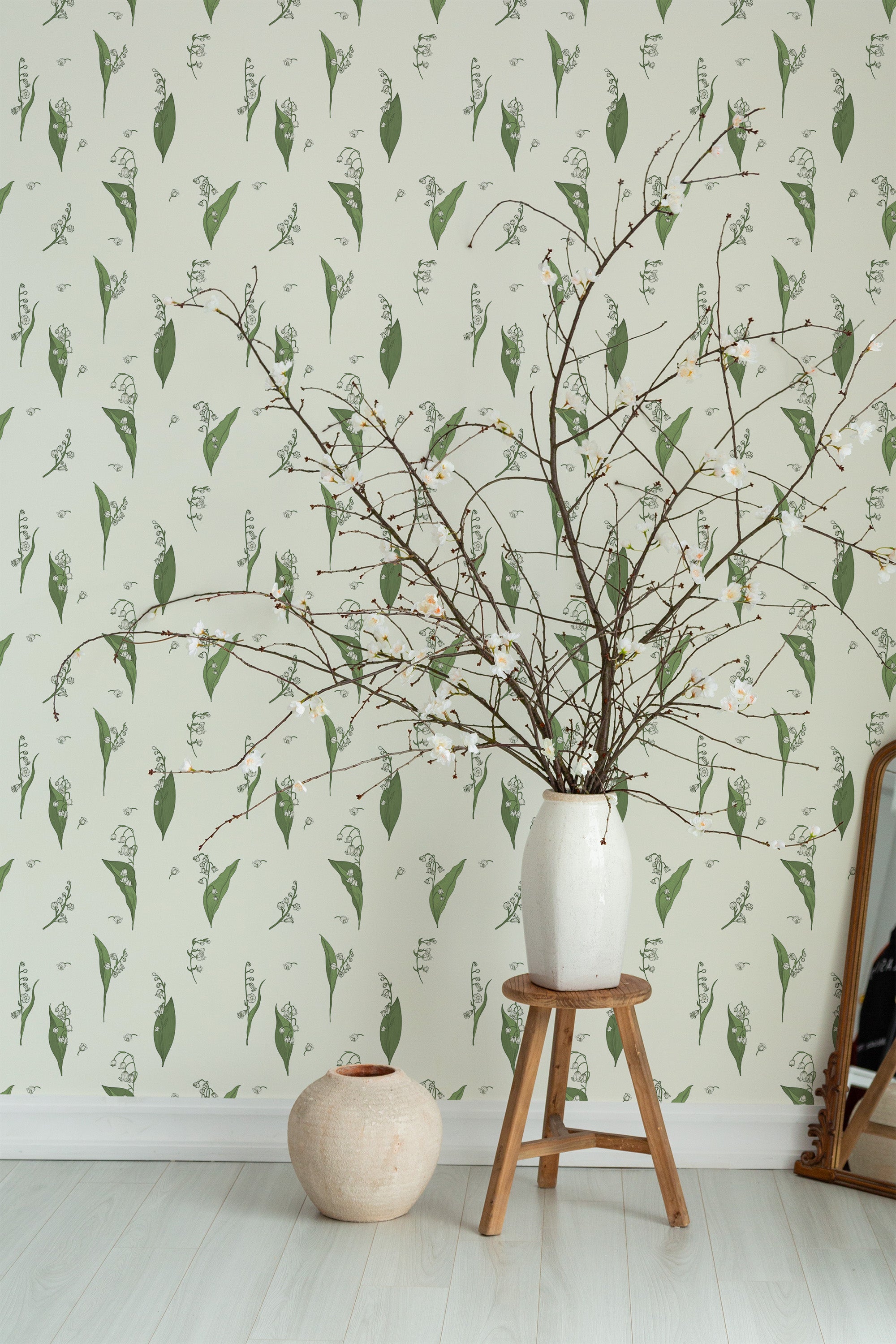 Self-adhesive wallpaper in minimal snow lilies design with delicate green botanical patterns spread evenly across a pale, light-colored background.