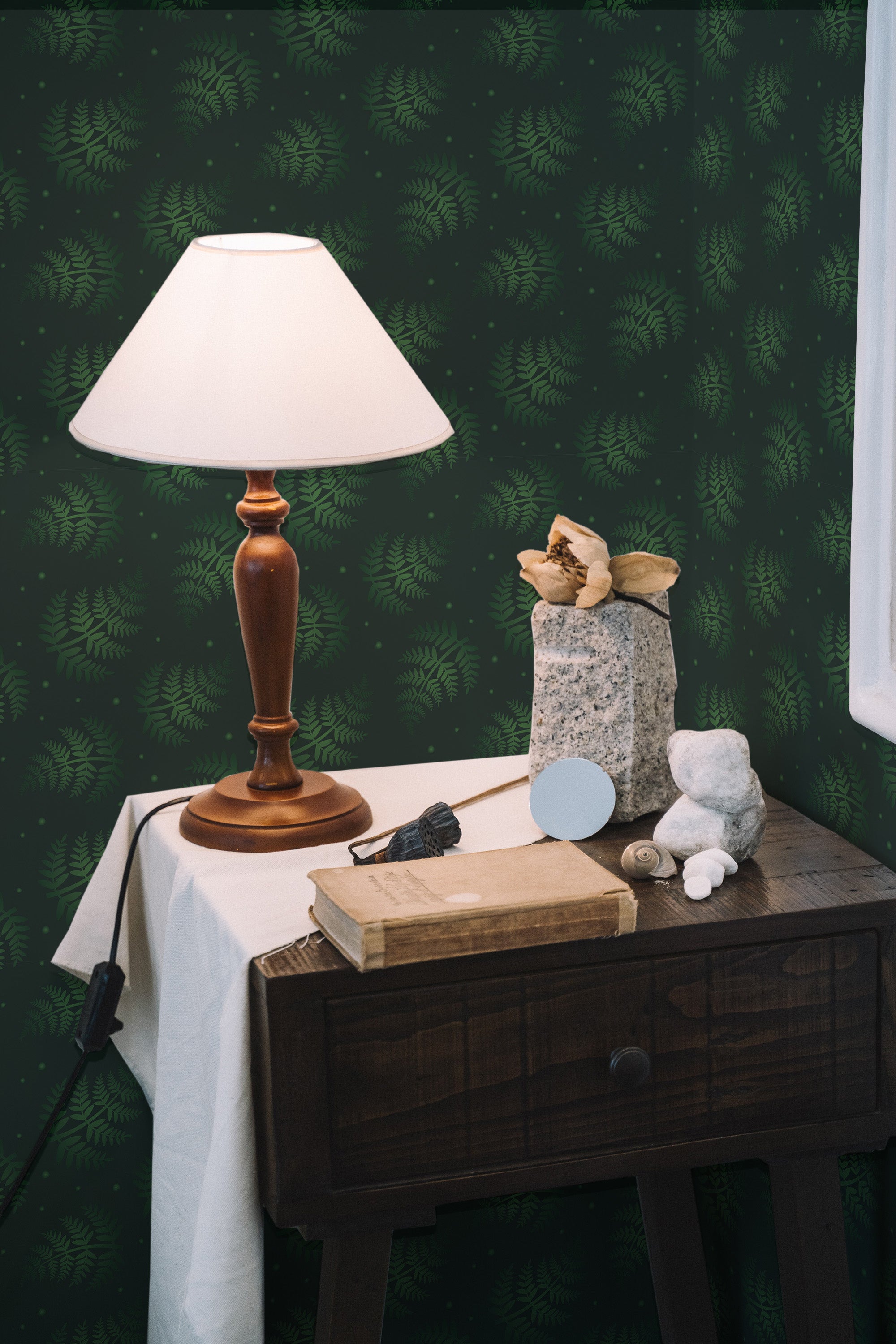 Self-adhesive dark green wallpaper with a repeating pattern of delicate fern leaves, adding a touch of nature and elegance to the room.