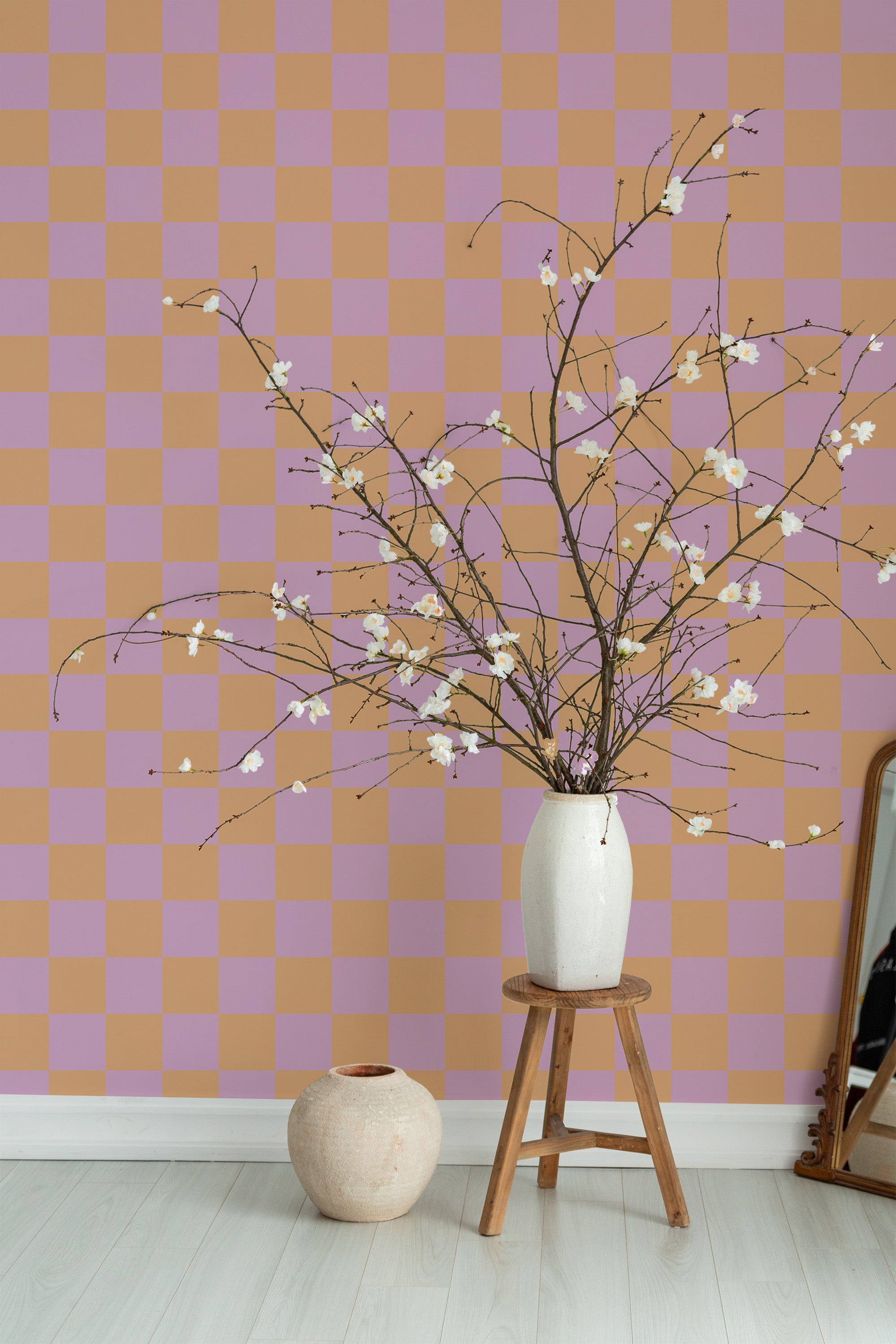 Self-adhesive wallpaper adorned with a pink and orange check design, creating a vibrant and modern pattern that adds warmth and visual interest to the room.