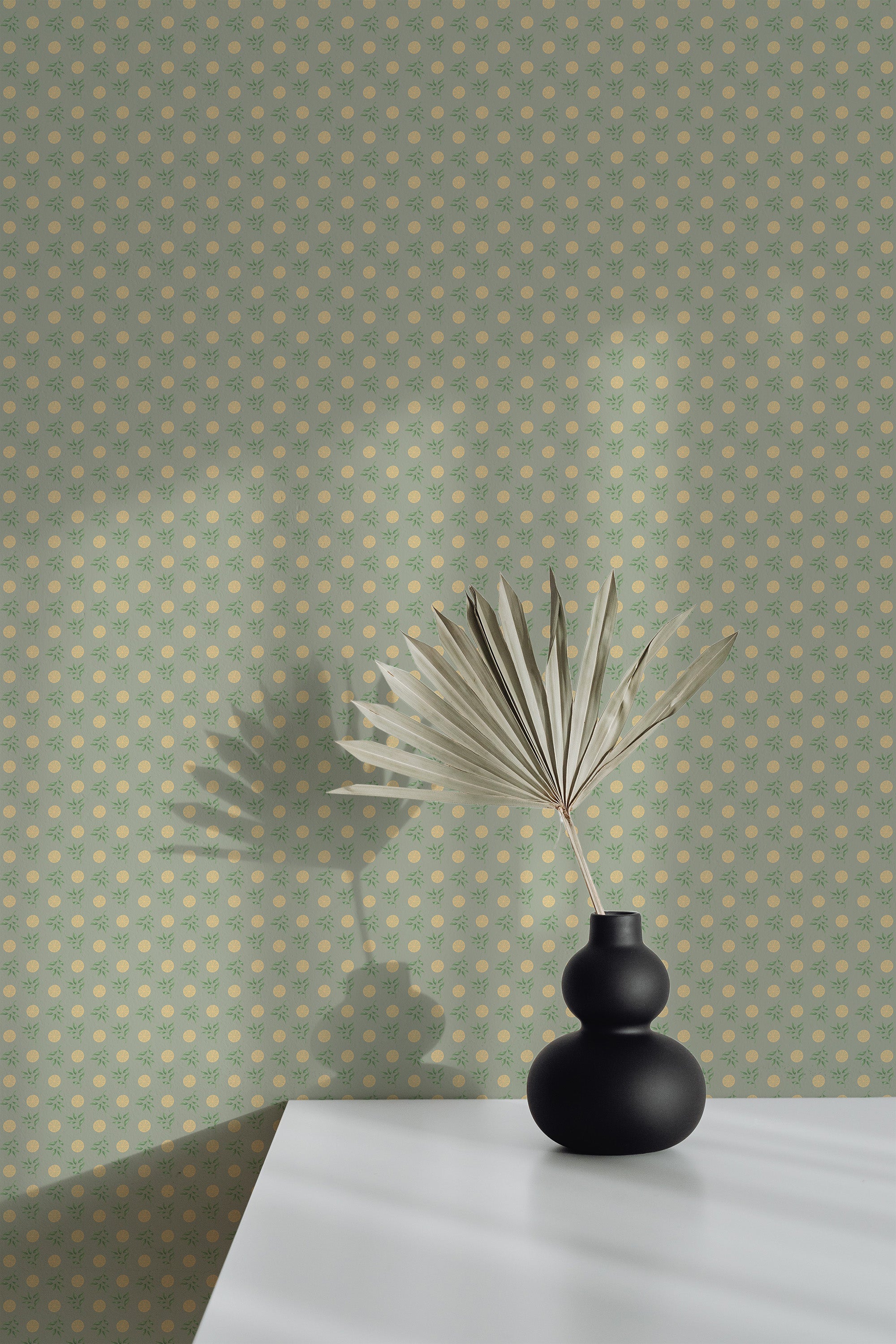 Self-adhesive wallpaper with a Clementine design featuring small orange circles and dots on a muted green background.