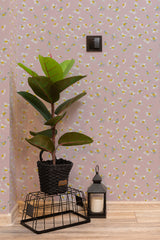 Self-adhesive wallpaper with flying daisies pattern against a pink background, complemented by a potted plant and a lantern beside it.