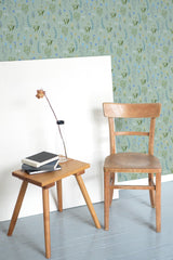 Self-adhesive wallpaper with a blue floral meadow design, showcasing delicate flowers and leafy stems on a soft, muted background.