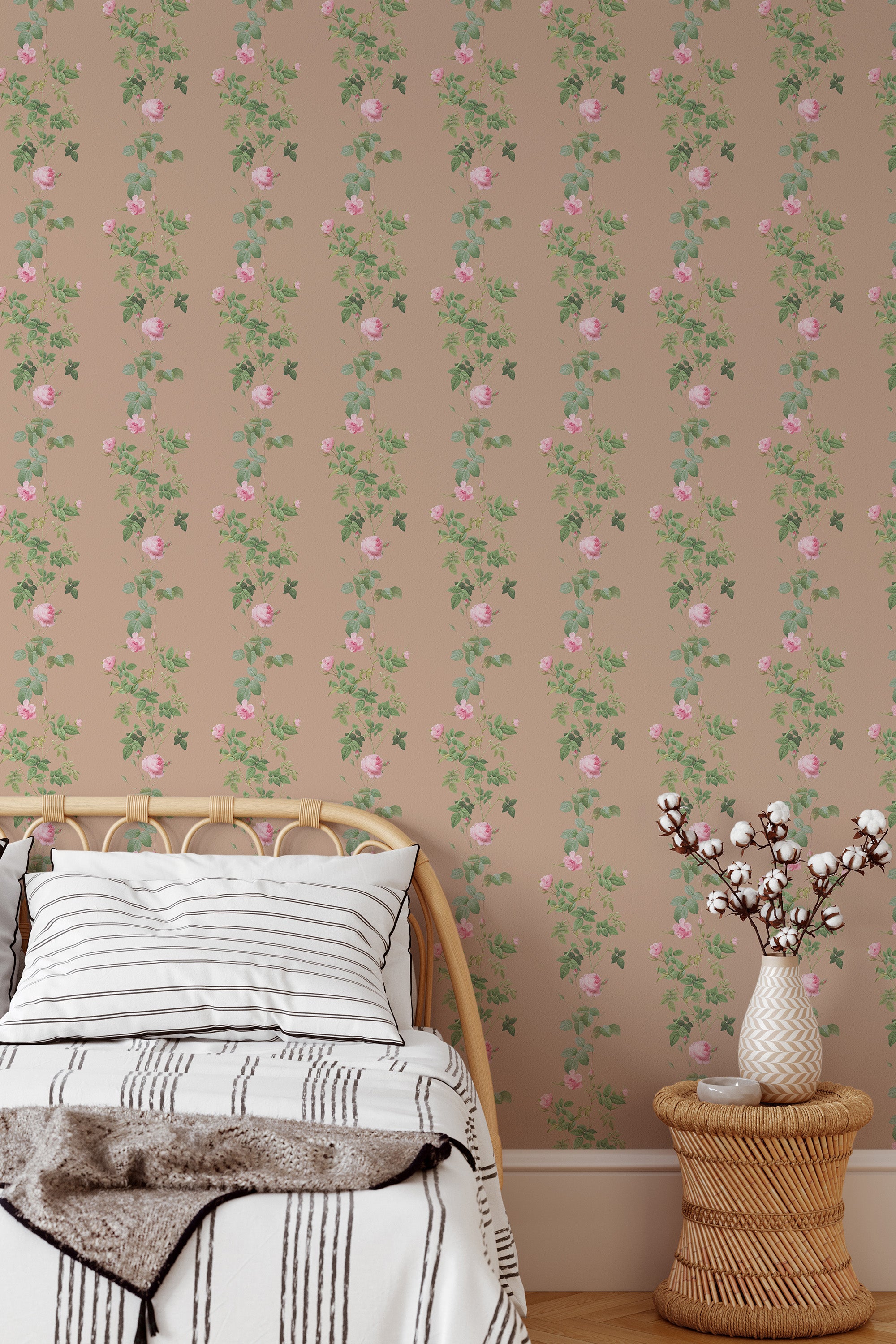 Self-adhesive wallpaper with a rose vine pattern, illustrating green leaves and pink blossoms on a taupe background, in a bedroom with a wooden bed and a vase with branches.
