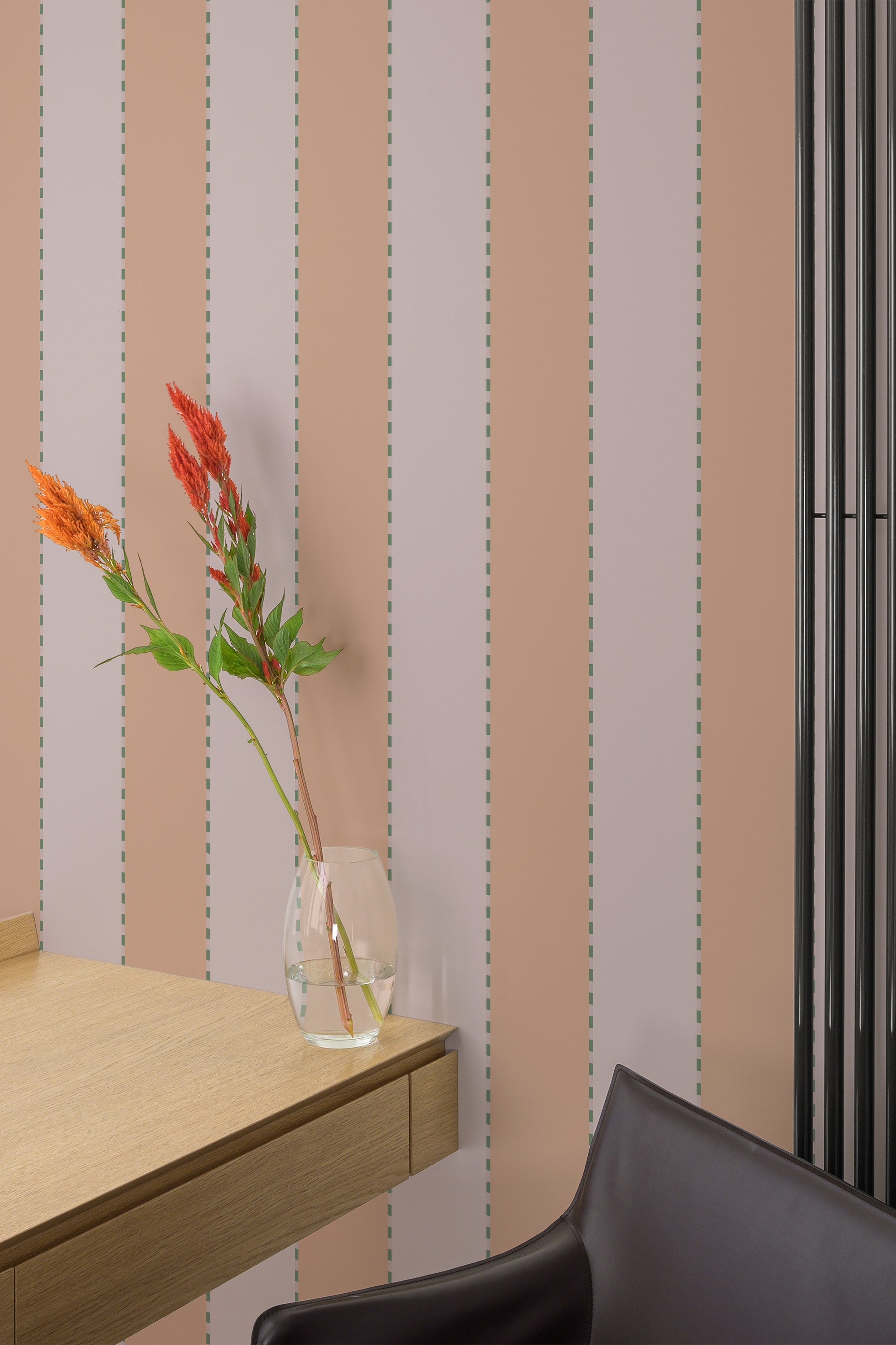 Self-adhesive pink fabric stripe design wallpaper with dotted lines on a room wall, complemented by a wooden table and chair, and a clear vase with flowers.