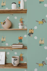 Self-adhesive wallpaper with illustrations of cute baby cartoon animals such as giraffes, lions, and owls in soft colors on a green background, adding a playful touch to the room's decor.