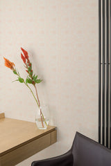 Self-adhesive mosaic-style wallpaper with a subtle geometric pattern in a warm neutral tone, accenting a modern room with a wooden shelf and a vase of flowers.