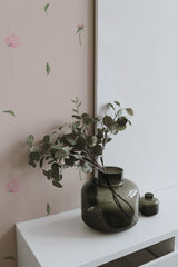 Self-adhesive Nursery roses wallpaper with a pattern of delicate pink roses and green leaves on a light background, enhancing a room's decor.