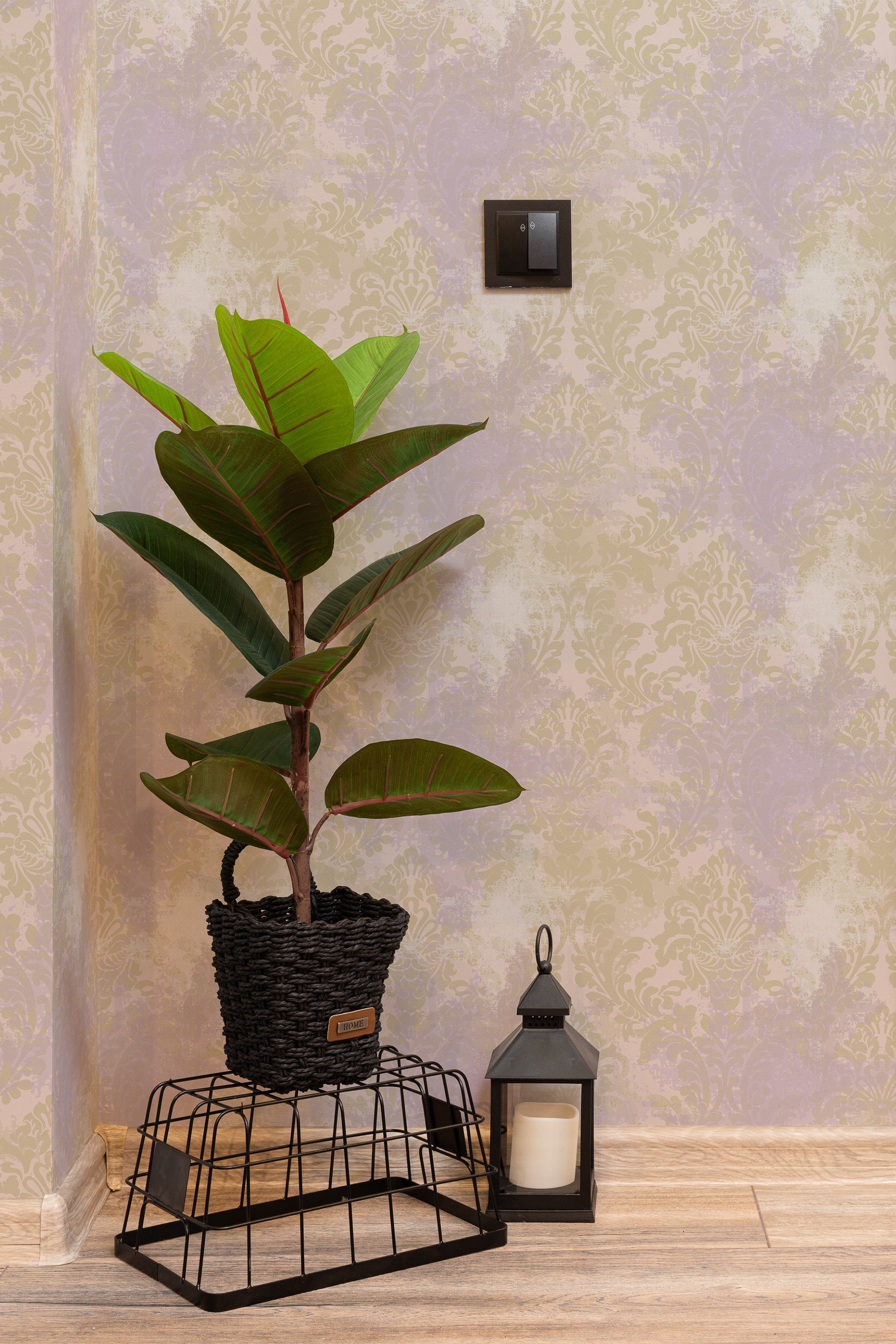Self-adhesive Purple damask wallpaper with intricate pattern on a room wall, accompanied by a potted plant and a lantern.