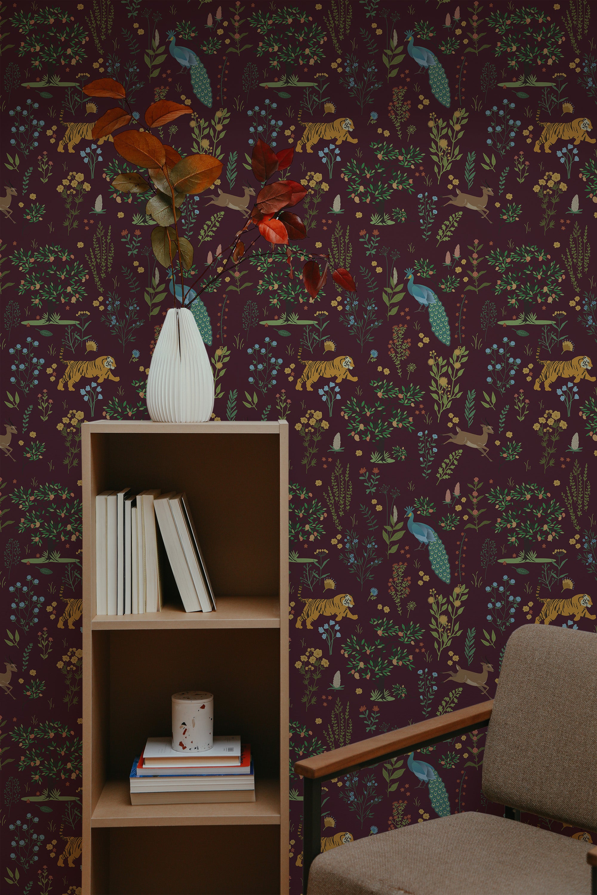 Self-adhesive burgundy wallpaper with a pattern of various animals and foliage on a feature wall, complemented by a wooden bookshelf and a chair.