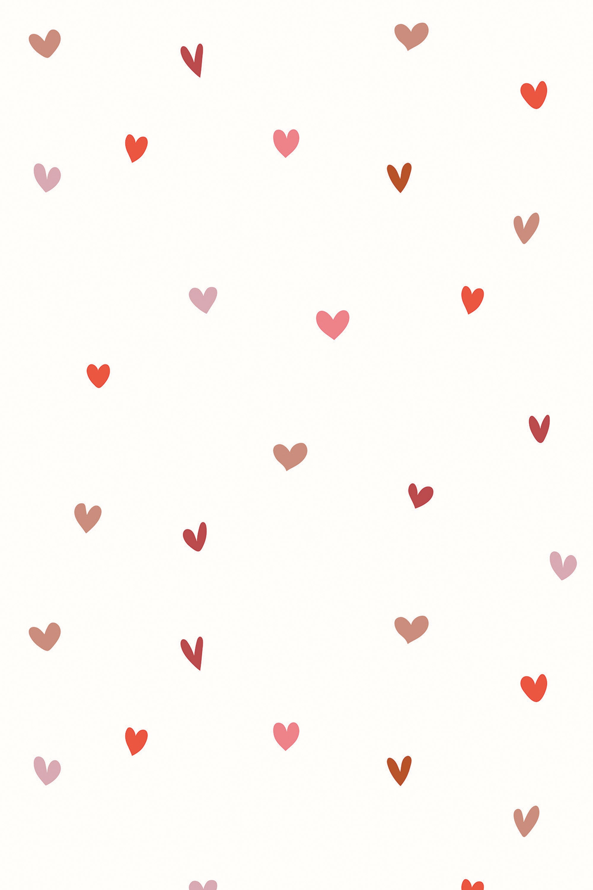 A pattern of scattered tiny hearts in shades of pink and red on a pale background, peel and stick removable wallpaper.