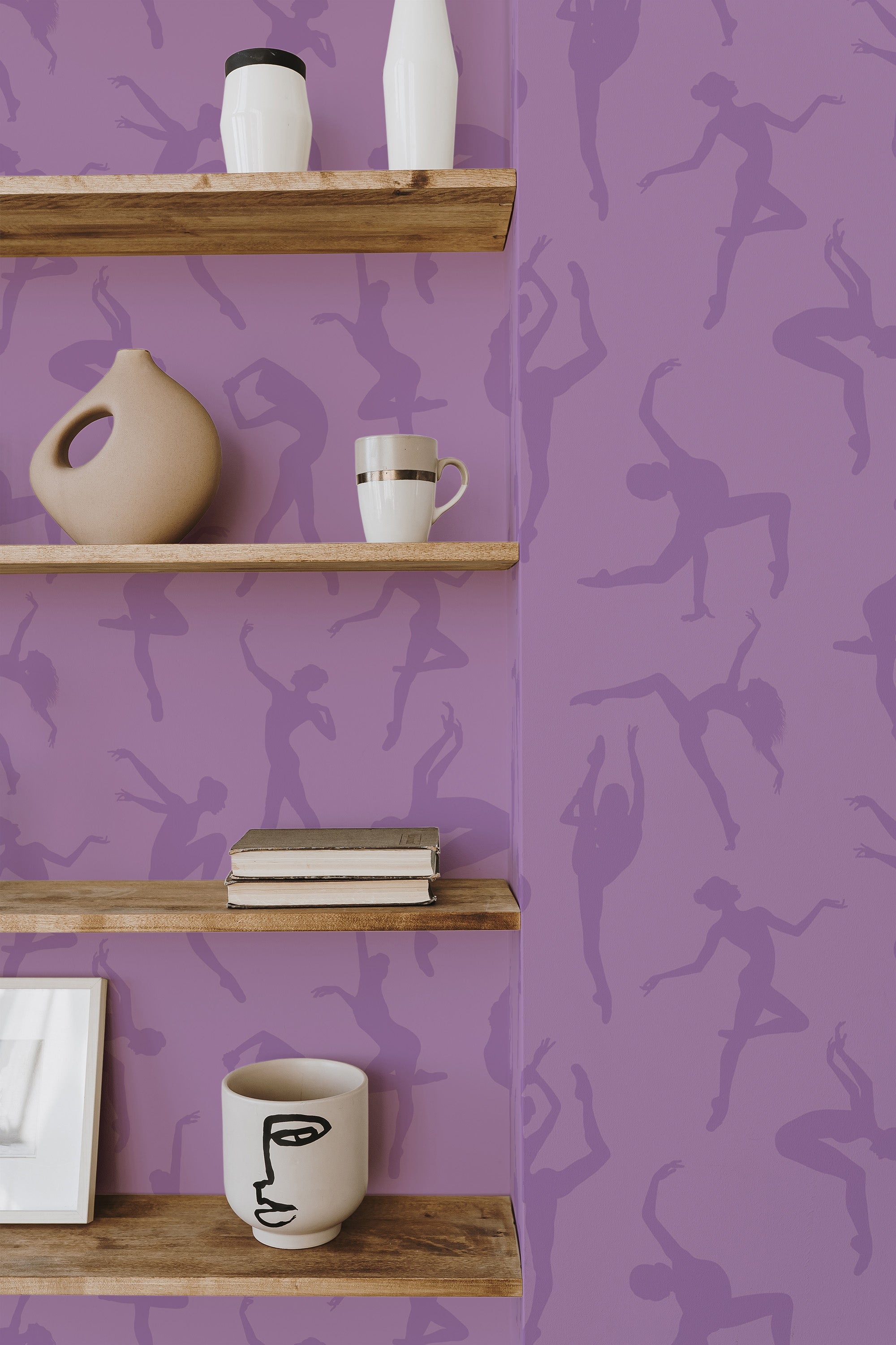 Self-adhesive purple wallpaper with silhouette patterns of ballerinas in various dance poses on the walls, complemented by wooden shelves holding decorative items.