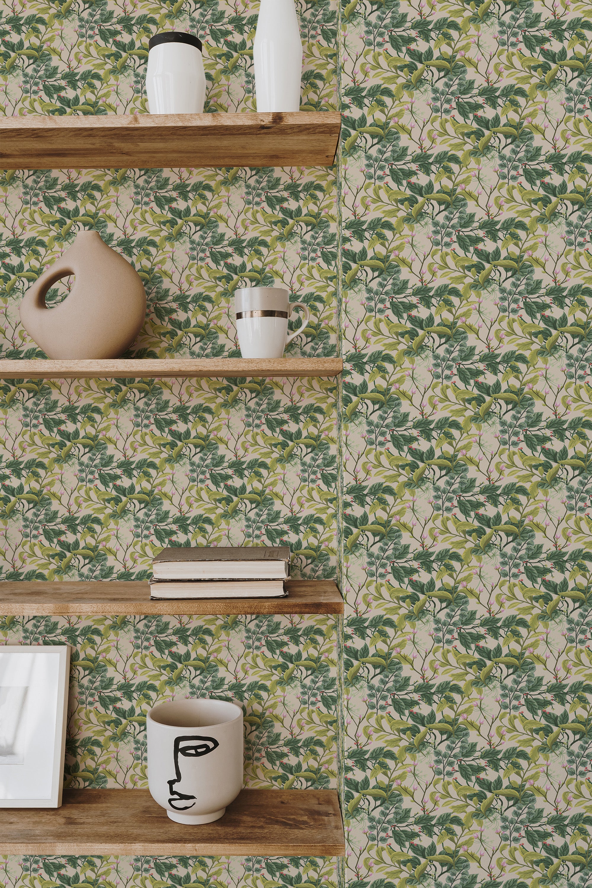 Self-adhesive wallpaper with a green and pink branch pattern on a beige background, accented by wooden shelves with decorative items.