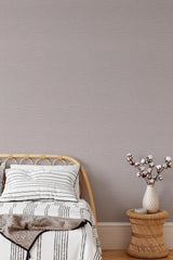 Self-adhesive Snakeskin-patterned wallpaper in a muted tone, accenting a modern bedroom with a stylish wicker vase and cozy bedding.