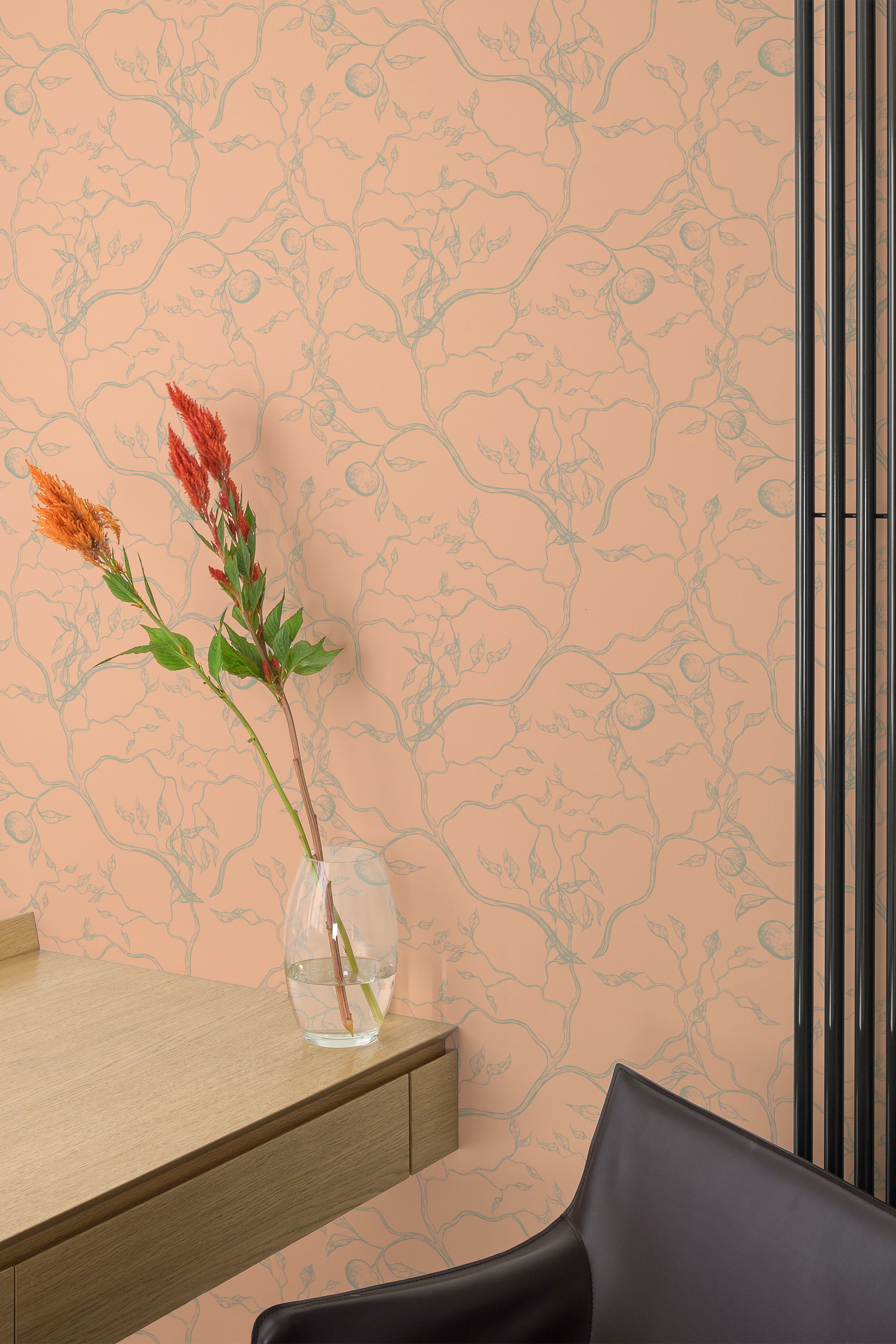 Self-adhesive wallpaper with a Peach Japanese tree pattern on a wall, accented with a vase of flowers and modern furniture.