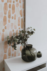 Self-adhesive Peachy Watercolor Drops wallpaper with abstract shapes in varying shades of peach and tan on a white background, adding a modern artistic touch to the room decor.