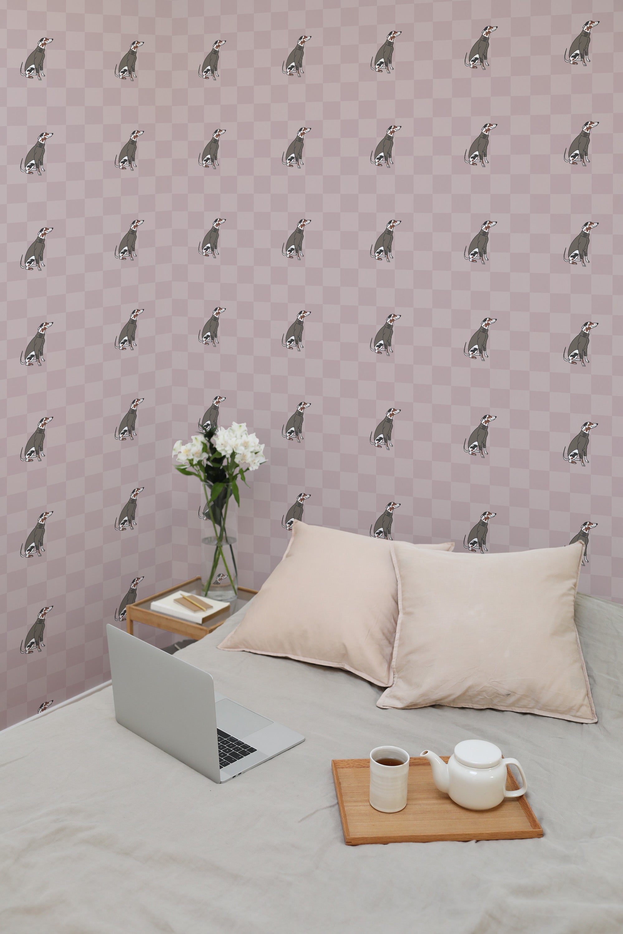 Self-adhesive wallpaper with repeated pattern of stylized Fashion Dog illustrations on a pink checkered background, in a room with a laptop and cushions on a bed.