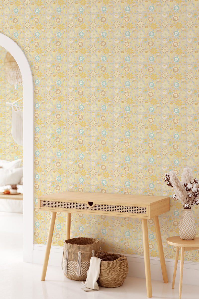 Vintage Scandinavian wallpaper with an intricate pattern of soft yellow and pale blue floral motifs forming a symmetrical, repeating design, creating a warm, cozy ambiance. Traditional wallpaper.