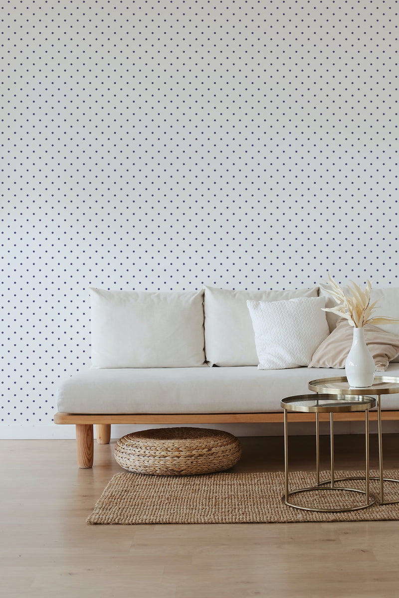 White wall with small purple polka dots evenly spaced throughout, providing a stylish contrast against the light-colored furniture. Traditional wallpaper.