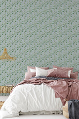 Hand-drawn flowers in soft green and pink tones gracefully repeat across the wall, adding a delicate and classic touch to the room's decor. Traditional wallpaper.