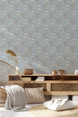 A wallpaper with a delicate pattern of vertical floral vines in soft blue, white, and red tones on a muted grey background, complementing the room's serene atmosphere. Traditional wallpaper.