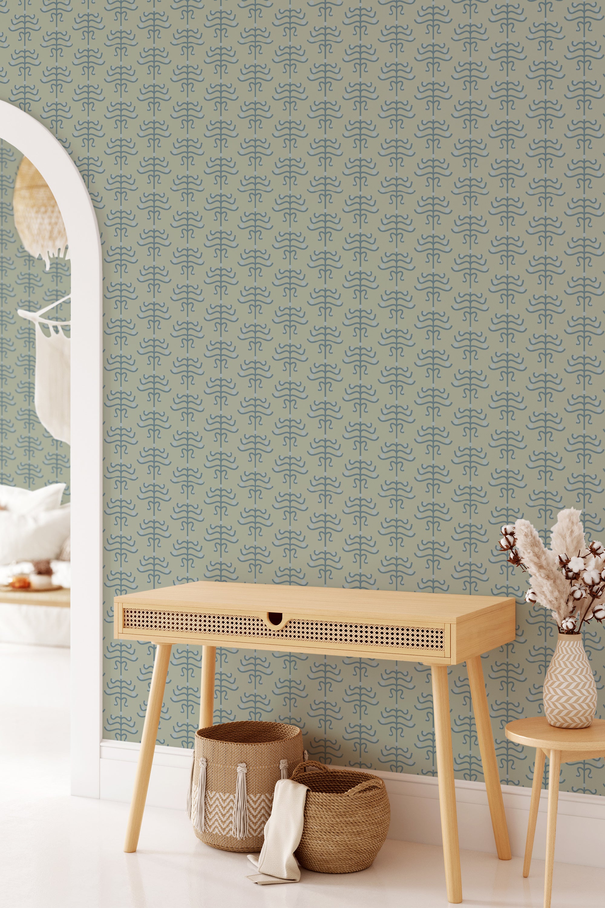 A room with Geometric floral art deco wallpaper in light green and blue tones combined in a repeating pattern covering the wall, traditional wallpaper.