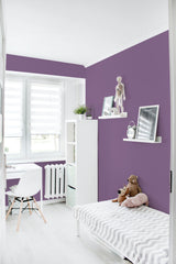 Room with a Solid Dusty Purple wallpaper that complements a minimalist space with white furniture and light flooring, offering a calming and elegant feel to the decor. Traditional wallpaper.