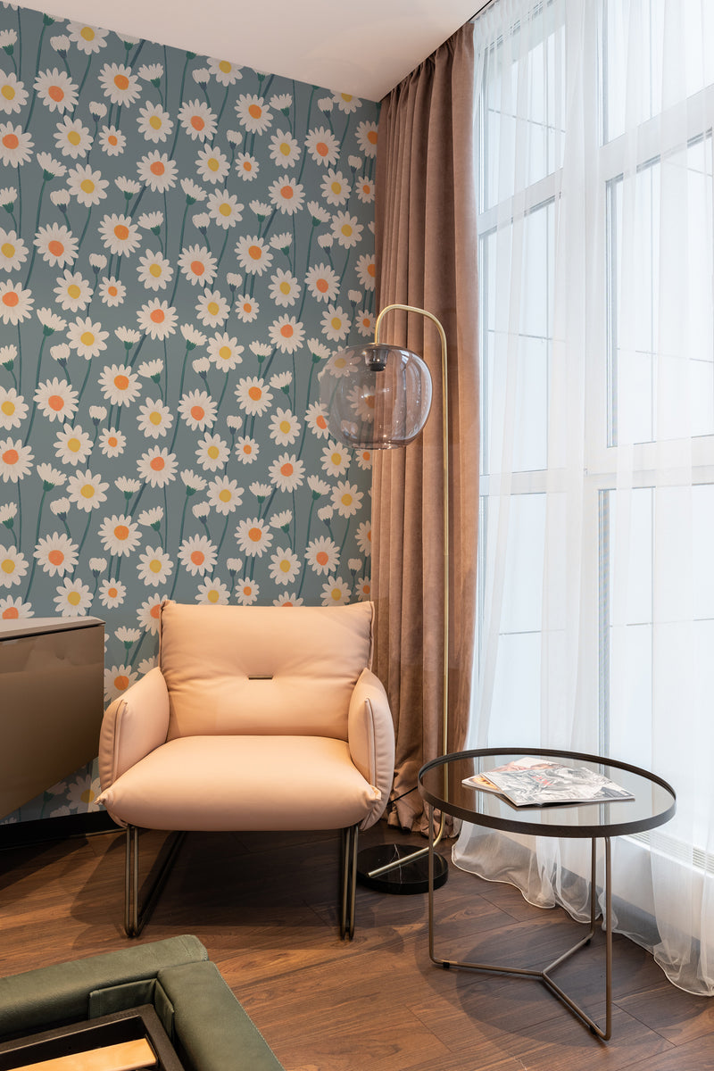 The wallpaper has a pattern of white daisies with yellow centers and green stems spread uniformly across a blue background, enhancing the room with a playful, floral atmosphere. Traditional wallpaper.